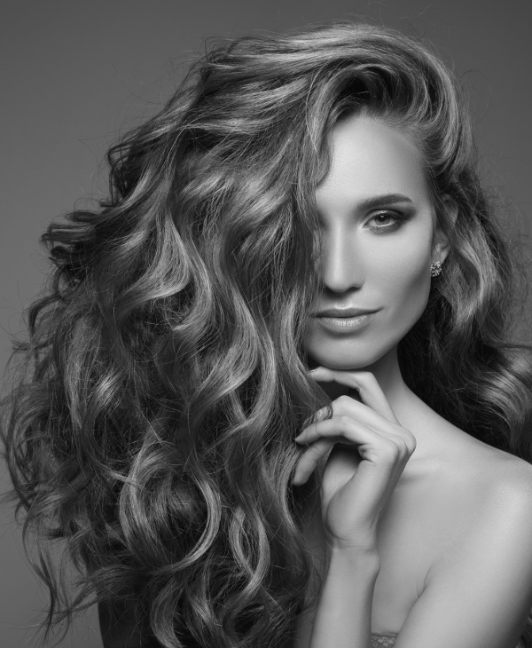 Portrait of woman with long curly beautiful ginger hair.